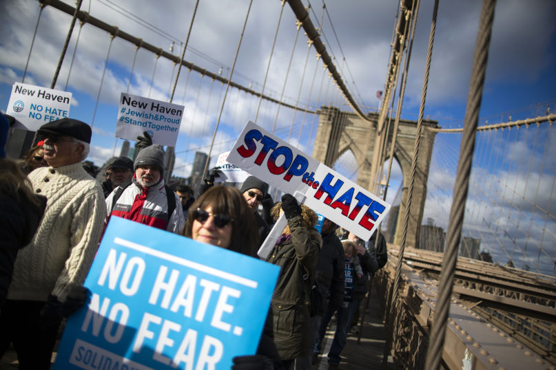 People take part in a march crossing the Brooklyn Bridge in solidarity with the Jewish community, after a recent string of anti-Semitic attacks throughout the greater New York area, on Jan. 5, 2020, in New York.  (AP Photo/Eduardo Munoz Alvarez)