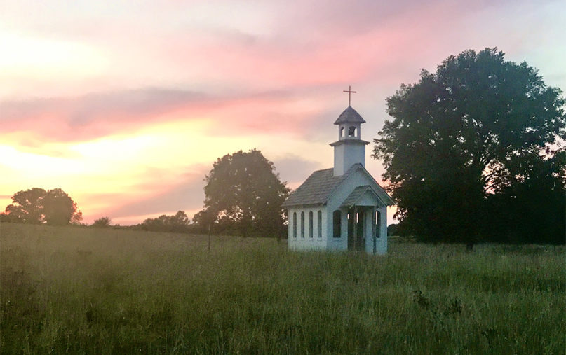 The sun sets behind the Christ family chapel in Wewoka, Oklahoma. Photo courtesy of Mary Evelyn Photography by Stacy Welch-Christ