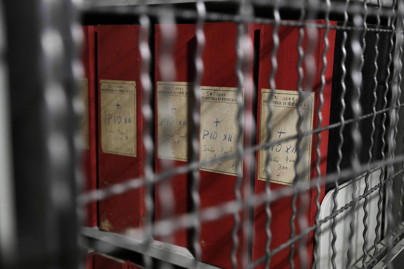 Folders marked with labels reading “Pius XII" are seen through a grating during a guided tour for media of the Vatican library on Pope Pius XII, at the Vatican, Thursday, Feb. 27, 2020. The Vatican’s apostolic library on Pope Pius XII, the World War II-era pope and his record during the Holocaust, opened to researchers on March 2, 2020. (AP Photo/Gregorio Borgia)