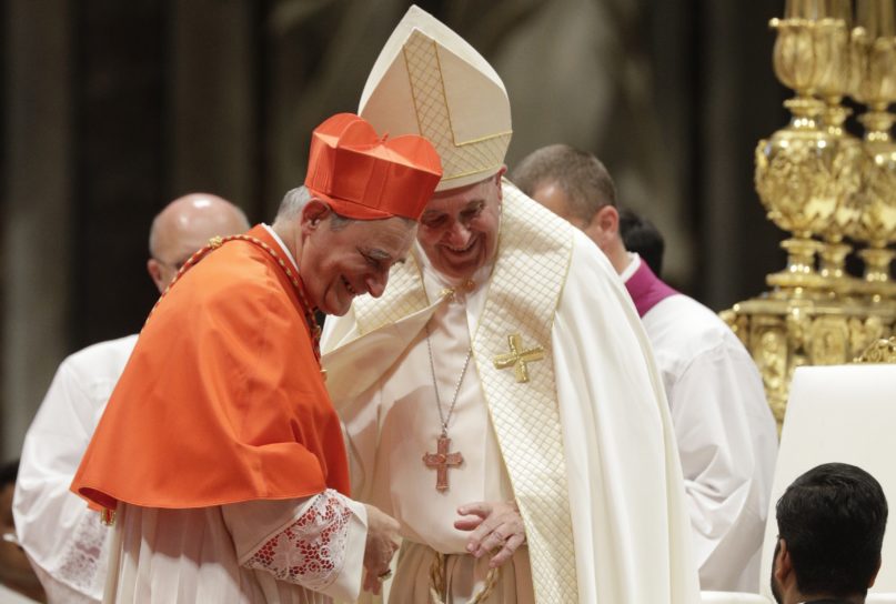 New Cardinal Matteo Maria Zuppi shares smile with Pope Francis during a consistory inside St. Peter's Basilica, at the Vatican, Saturday, Oct. 5, 2019. Pope Francis has chosen 13 men he admires and whose sympathies align with his to become the Catholic Church's newest cardinals. (AP Photo/Andrew Medichini)