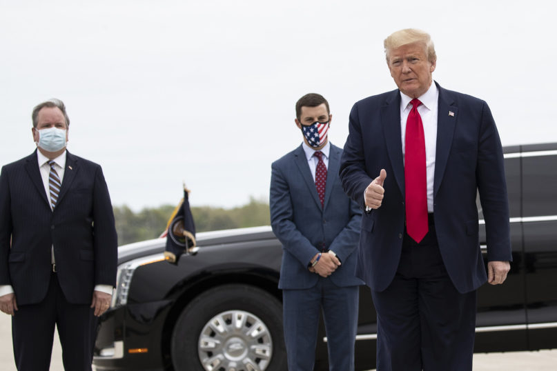 President Donald Trump gives thumbs up after stepping off Air Force One as he arrives at Detroit Metro Airport, behind him are Kurt Heise, left, Supervisor of Plymouth Township, Mich., and Speaker Lee Chatfield, of the Michigan House of Representatives, Thursday, May 21, 2020, in Detroit. Trump will visit a Ypsilanti, Mich., Ford plant that has been converted to making personal protection and medical equipment. (AP Photo/Alex Brandon)
