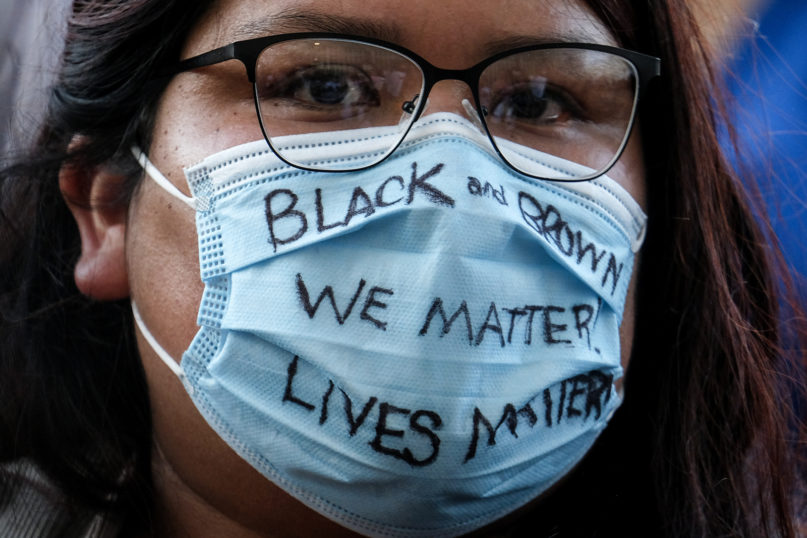 A demonstrator wears a mask with a message during a protest of the death of George Floyd, a Black man who was in police custody in Minneapolis, in downtown Los Angeles, on May 27, 2020. (AP Photo/Ringo H.W. Chiu)