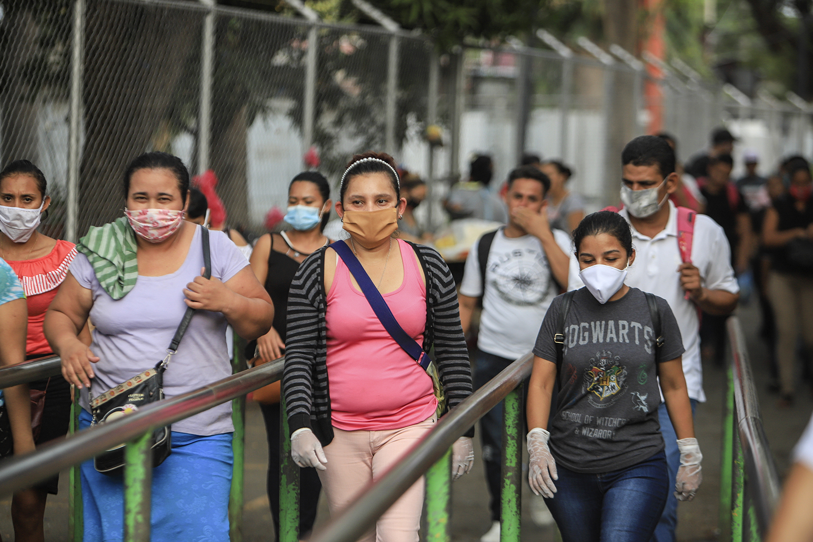 ...masks as a protection against the spread of the new coronavirus as they ...