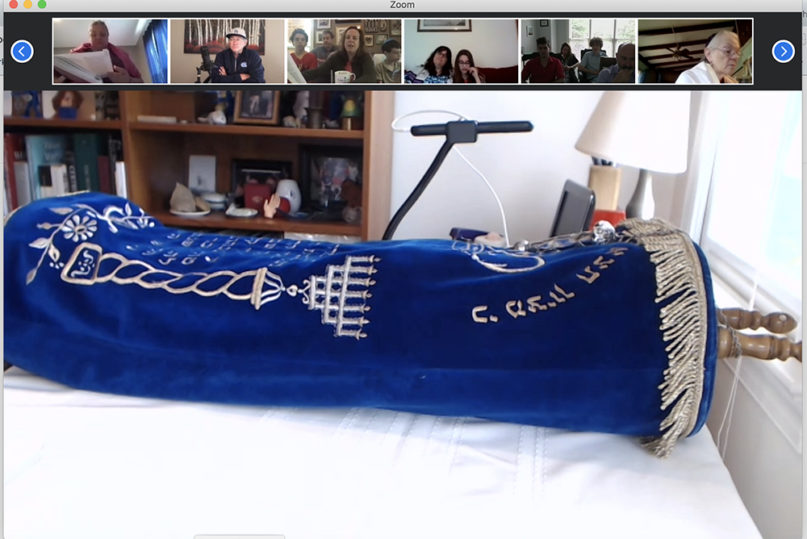 The Tokaj Torah lies on a table at Henry Fuchs’ home, while members of the Kehillah Synagogue watch via an online Zoom meeting, April 25, 2020. Video screen grab