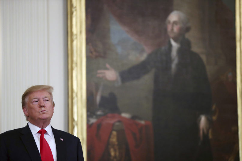 President Donald Trump stands near a portrait of George Washington at a Wounded Warrior Project Soldier Ride event in the East Room of the White House on April 18, 2019, in Washington. (AP Photo/Andrew Harnik)