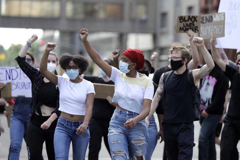 A group marches to Jefferson Square in Louisville, Kentucky, on June 2, 2020, to protest the deaths of George Floyd and Breonna Taylor. Taylor, a Black woman, was fatally shot by police in her home in March. (AP Photo/Darron Cummings)
