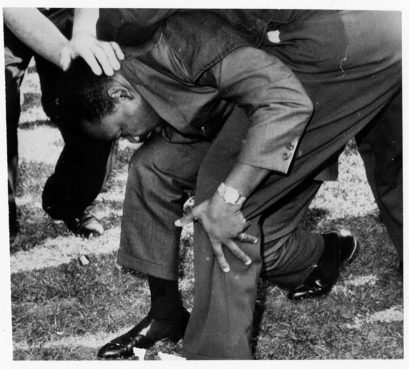 Dr. Martin Luther King, Jr. is struck by a rock during a march in Chicago on August 5, 1966. RNS archive photo
