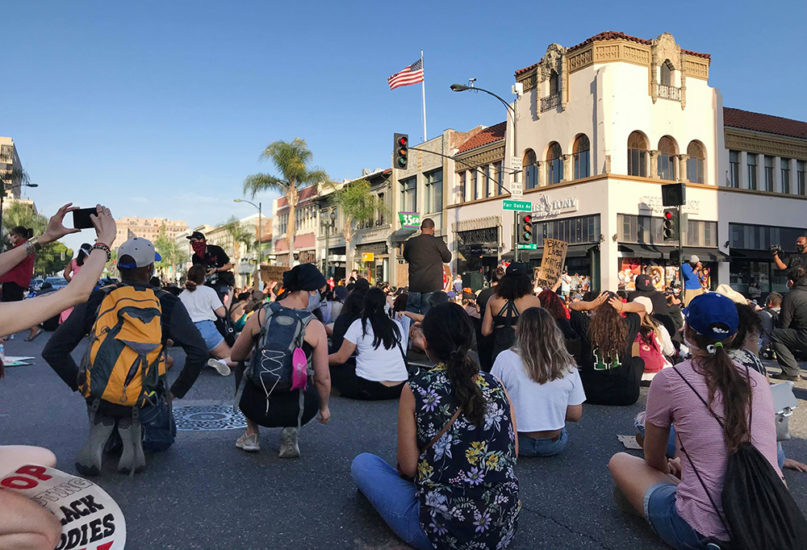 Demonstrators sit and listen to speakers at the intersection of Fair Oaks Avenue and Colorado Boulevard in Pasadena, California, Thursday, June 4, 2020. Photo by April Lindh