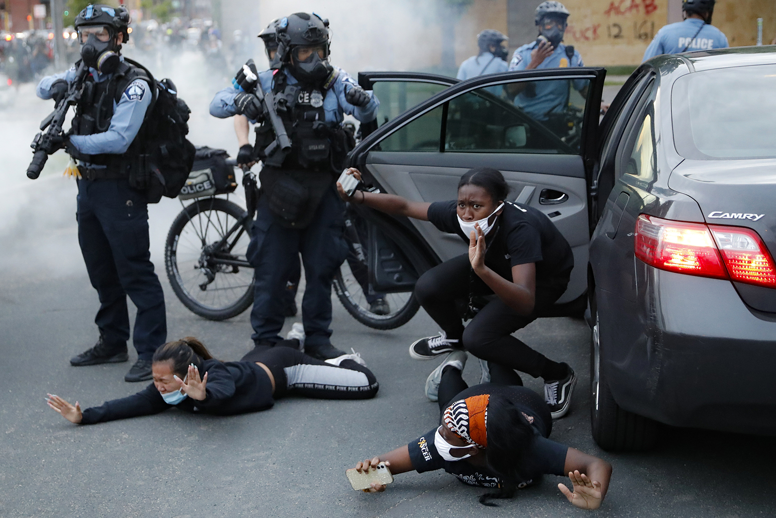 Motorists are ordered to the ground from their vehicle by police during a protest on South Washington Street, Sunday, May 31, 2020, in Minneapolis. Protests continued following the death of George Floyd, who died after being restrained by Minneapolis police officers on Memorial Day. (AP Photo/John Minchillo)