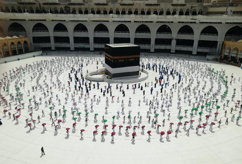 Hundreds of Muslim pilgrims circumambulate around the Kaaba, the cubic building at the Grand Mosque, as they keep social destination to protect themselves against Coronavirus a ahead of the Hajj pilgrimage in the Muslim holy city of Mecca, Saudi Arabia, Wednesday, July 29, 2020. (AP Photo)