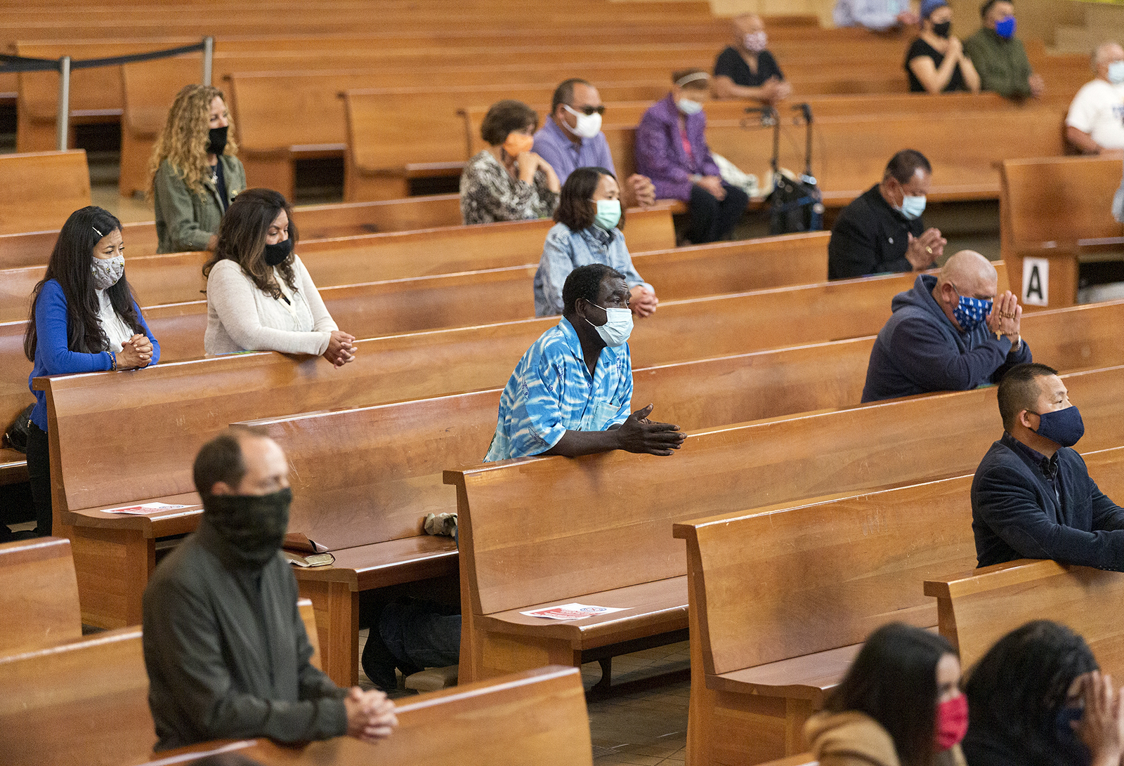 Congregants kneel and observe social distancing while listening to Los Angeles Archbishop Jose H. Gomez celebrate Mass at Cathedral of Our Lady of the Angels in downtown Los Angeles on June 7, 2020. (AP Photo/Damian Dovarganes)