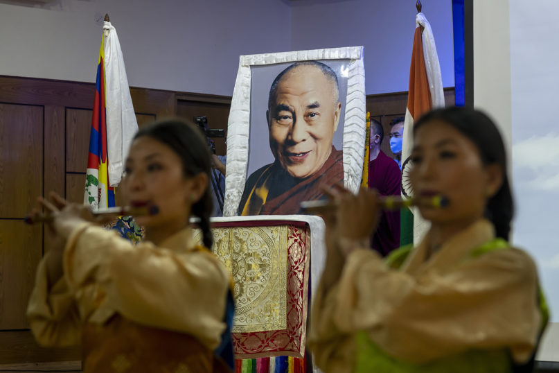 Exiled Tibetan artists perform a special song to mark the 85th birthday of their spiritual leader, the Dalai Lama, whose portrait is seen behind at an official function in Dharmsala, India, on July 6, 2020. (AP Photo/Ashwini Bhatia)