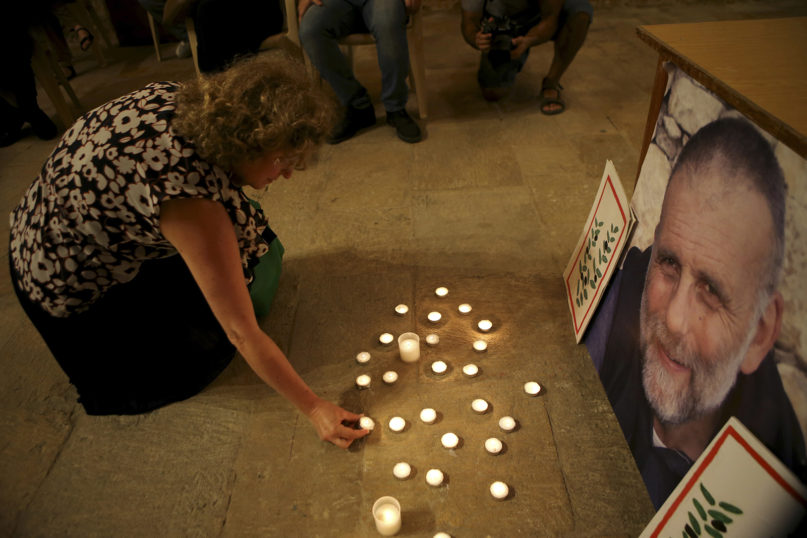 A Lebanese woman lights a candle in front of a portrait of the Rev. Paolo Dall’Oglio, an Italian Jesuit priest who was kidnapped in Syria in 2013, during a vigil for him at St. Joseph Church in Beirut on July 29, 2015. Activists reported that Dall’Oglio went missing in July 2013 while on a trip to the rebel-held northeastern city of Raqqa. Dall’Oglio is an opponent of Syrian President Bashar Assad and was expelled in 2012 from Syria, where he had lived for 30 years. (AP Photo/Hussein Malla)