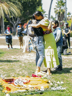 Jessa Calderon, right, cries and embraces another demonstrator following the toppling of a Junipero Serra statue June 20, 2020, in downtown Los Angeles at Father Serra Park. Photo by Erick Iñiguez