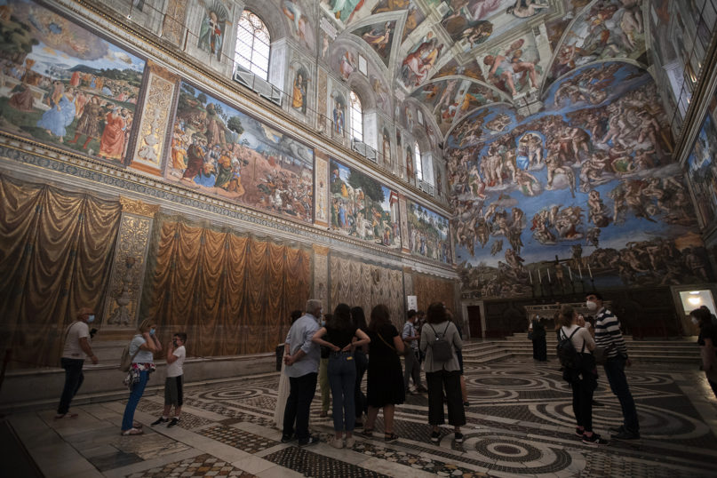 A small amount of visitors admire the Sistine Chapel as the Vatican Museums reopened, in Rome, Monday, June 1, 2020. (AP Photo/Alessandra Tarantino)