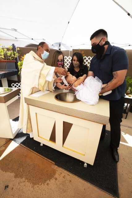 An outdoor baptism at Our Lady Queen of Angels Church, known as “La Placita,” in Los Angeles, in August 2020. Photo by Víctor Aleman/Archdiocese of Los Angeles