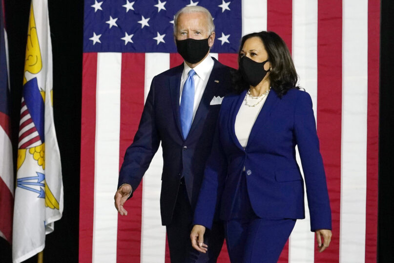 Democratic President-elect Joe Biden and Vice President-elect Kamala Harris arrive to speak at a news conference at Alexis Dupont High School in Wilmington, Delaware, on Aug. 12, 2020. (AP Photo/Carolyn Kaster)