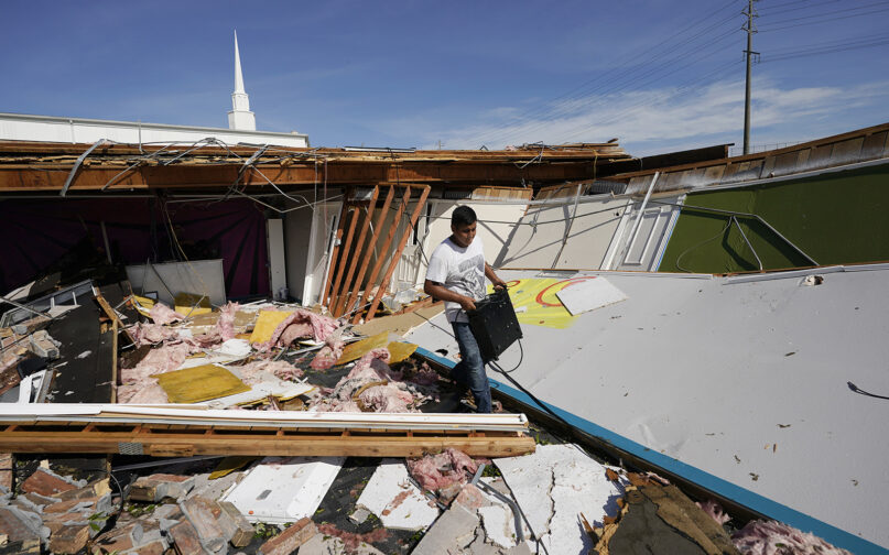 Benjamin Luna helps recover items from the children’s wing of the First Pentecostal Church, which was destroyed by Hurricane Laura, on Aug. 27, 2020, in Orange, Texas. (AP Photo/Eric Gay)