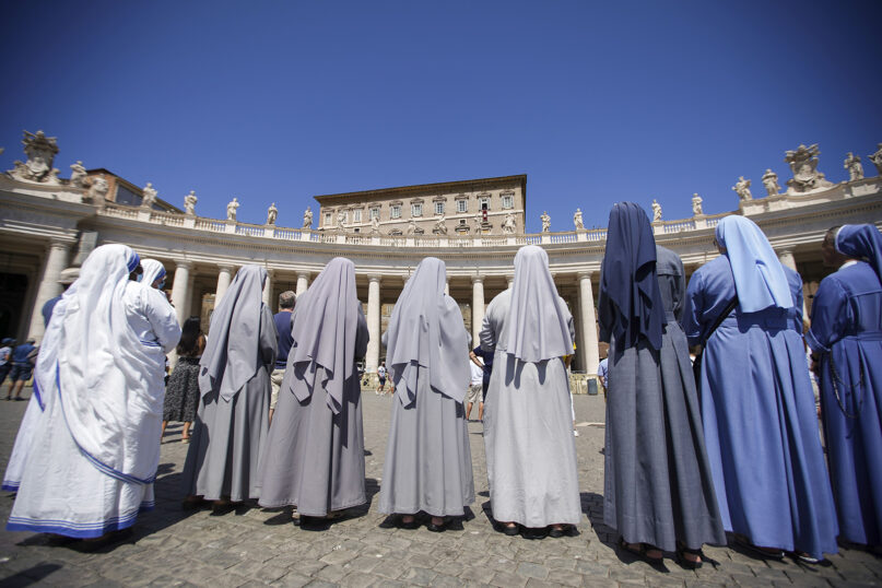 Nuns follow Pope Francis as he recites the Angelus noon prayer from the window of his studio overlooking St.Peter's Square, at the Vatican, Sunday, Aug. 16, 2020. (AP Photo/Andrew Medichini)