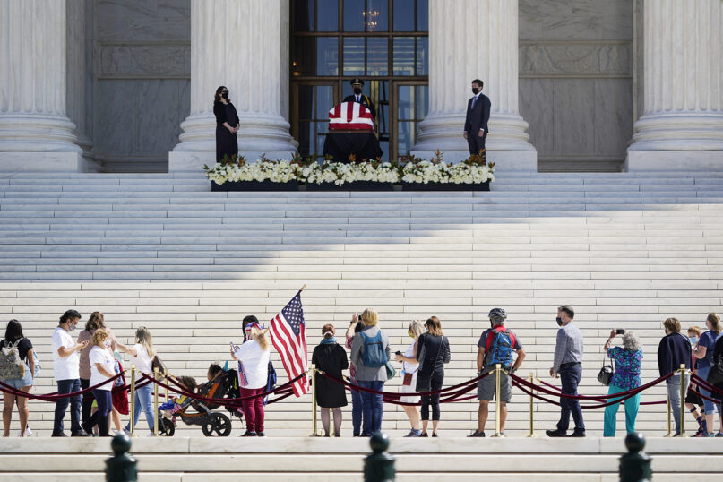 People pay respects as Justice Ruth Bader Ginsburg lies in repose under the portico at the top of the front steps of the U.S. Supreme Court building on Sept. 23, 2020, in Washington. Ginsburg, 87, died of cancer on Sept. 18. (AP Photo/J. Scott Applewhite)