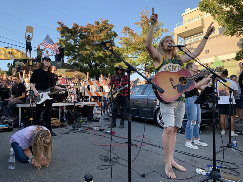 California musician Sean Feucht, right, performs with his band on a dead-end street near Seattle’s Gas Works Park after the city refused him access to the park for a Labor Day concert, Sept. 7, 2020. RNS photo by Julia Duin