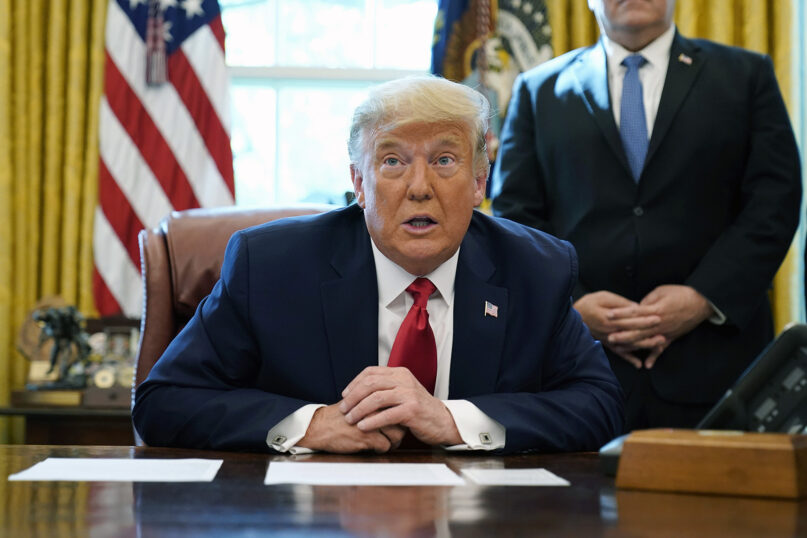 President Donald Trump speaks while on a phone call in the Oval Office of the White House, Friday, Oct. 23, 2020, in Washington. (AP Photo/Alex Brandon)