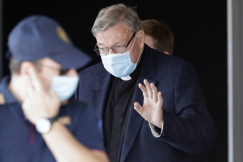 Australian Cardinal George Pell waves as he arrives at Rome's international airport in Fiumicino, Wednesday, Sept. 30, 2020. Pell took a leave of absence from his job in 2017 to stand trial in his native Australia on historic child sexual abuse charges, for which he was ultimately acquitted. (AP Photo/Andrew Medichini)