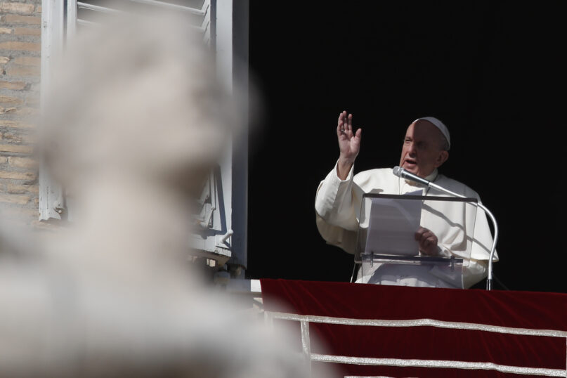 Pope Francis delivers his blessing during the Angelus noon prayer he recited from the window of his studio overlooking St.Peter's Square, at the Vatican, Sunday, Nov. 22, 2020. (AP Photo/Alessandra Tarantino)