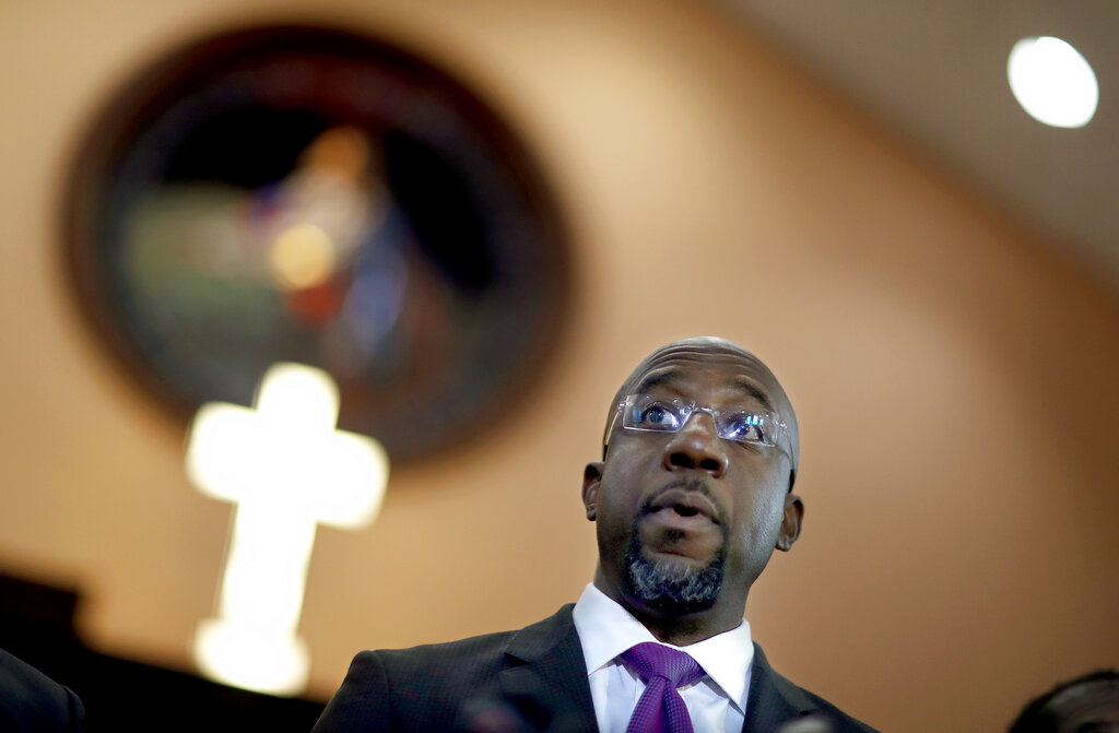 FILE - In this Jan. 12, 2018 file photo Rev. Raphael Warnock speaks at Ebenezer Baptist Church in Atlanta. Former President Barack Obama is endorsing Warnock in the race to fill a U.S. Senate seat in Georgia. Warnock is one of the Democrats running in a crowded field for the special election to be held Nov. 3, 2020. The seat is currently held by Republican Kelly Loeffler, a wealthy businesswoman who was appointed earlier this year by Republican Gov. Brian Kemp. (AP Photo/David Goldman, File)