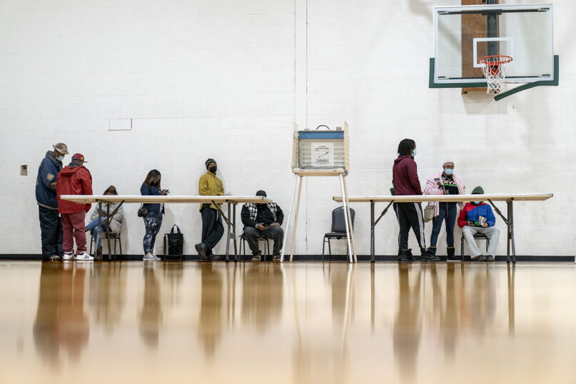Voters wait in line to fill out a ballot on the last day of early absentee voting before tomorrow's general election at the Northwest Activities Center in Detroit, Monday, Nov. 2, 2020. Michigan was one of several states with a high Muslim voter turnout. (AP Photo/David Goldman)