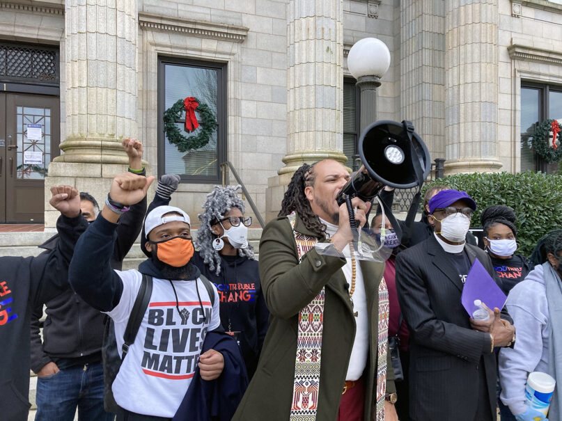 The Rev. Greg Drumwright, center, speaks in front of the Alamance County  Courthouse during a march for criminal justice reform in Graham, North Carolina, on Nov. 29, 2020. At center right, in a purple cap, is the Rev. Anthony Spearman, North Carolina president of the NAACP. RNS photo by Yonat Shimron