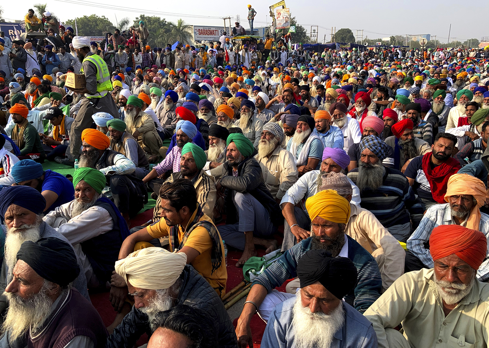 Indian farmers protesting new agriculture laws hold a meeting at the Delhi-Haryana state border, Monday, Nov. 30, 2020. Indian Prime Minister Narendra Modi tried to placate thousands of farmers protesting new agriculture laws Monday. While trying to march toward New Delhi, the farmers, using their tractors, have cleared concrete blockades, walls of shipping containers and horizontally parked trucks after police had set them up as barricades and dug trenches on highways to block roads leading to the capital. (AP Photo/Rishi Lekhi)
