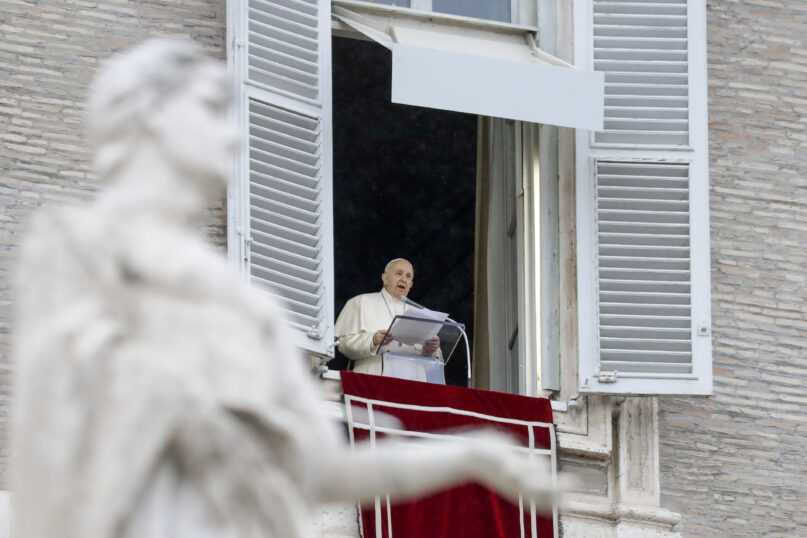 Pope Francis delivers his blessing as he recites the Angelus noon prayer from the window of his studio overlooking St.Peter's Square, at the Vatican, Sunday, Dec. 6, 2020. (AP Photo/Andrew Medichini)