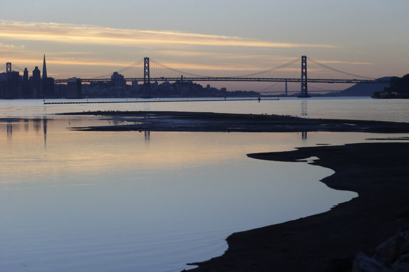 The sun sets on the San Francisco skyline in a view from Middle Harbor Shoreline Park on Thursday, Dec. 26, 2013, in Oakland, Calif. (AP Photo/Marcio Jose Sanchez)