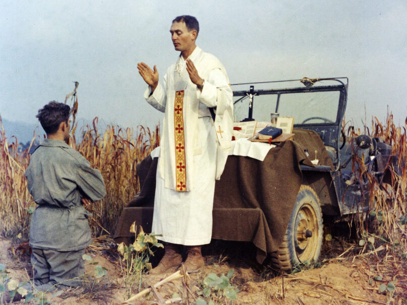 The Rev. Emil Kapaun celebrates Mass, using the hood of his jeep as an altar, as his assistant, Patrick J. Schuler, kneels in prayer in Korea on Oct. 7, 1950, less than a month before Kapaun was taken prisoner. The priest died in a prisoner of war camp on May 23, 1951, his body wracked by pneumonia and dysentery. On April 11, 2013, President Barack Obama awarded the legendary chaplain, credited with saving hundreds of soldiers during the Korean War, the Medal of Honor posthumously. (Photo by U.S. Army Col. Raymond A. Skeehan/courtesy of the Father Kapaun Guild)