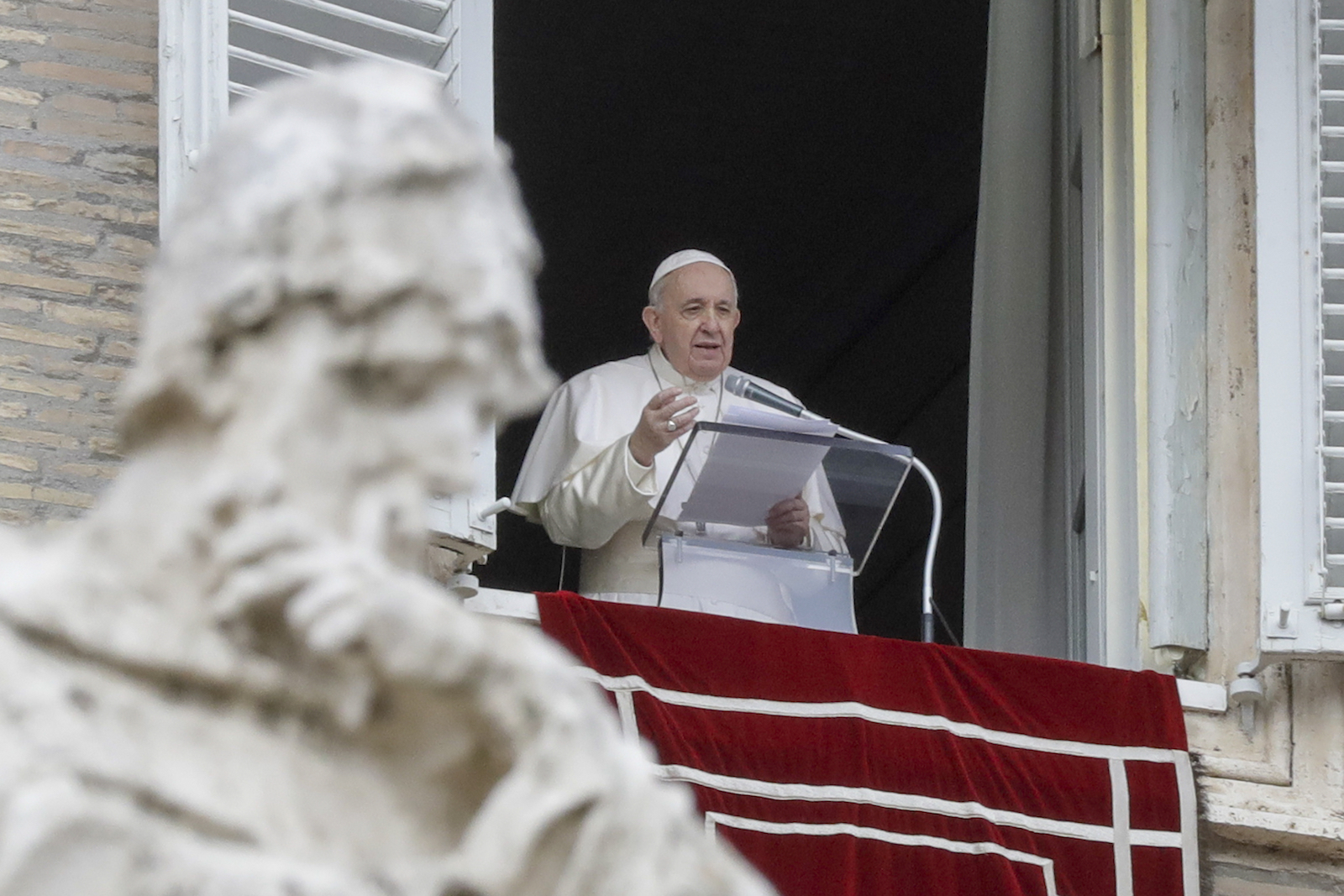 Pope Francis delivers his blessing as he recites the Angelus noon prayer from the window of his studio overlooking St. Peter’s Square, at the Vatican, Tuesday, Dec. 8, 2020. (AP Photo/Andrew Medichini)