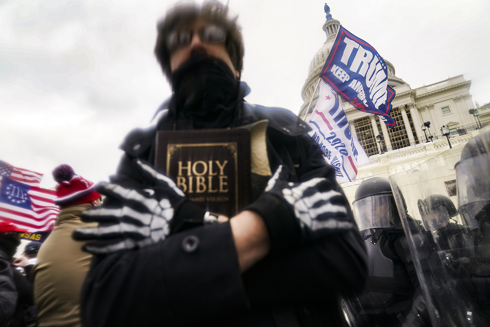 A demonstrator carries a Bible outside the Capitol on Jan. 6, 2021, in Washington. (AP Photo/John Minchillo)