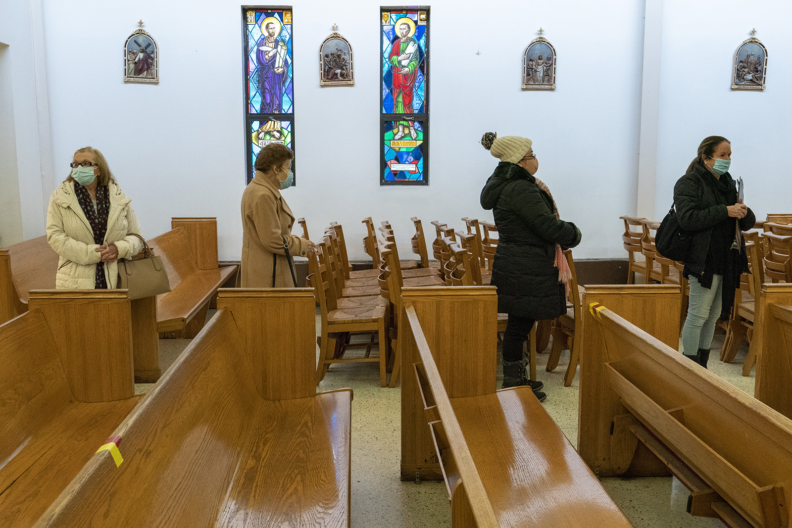 People line up next to the pews at a pop-up COVID-19 vaccination site at St. Luke's Episcopal Church, Jan. 26, 2021, in the Bronx borough of New York. (AP Photo/Mary Altaffer)