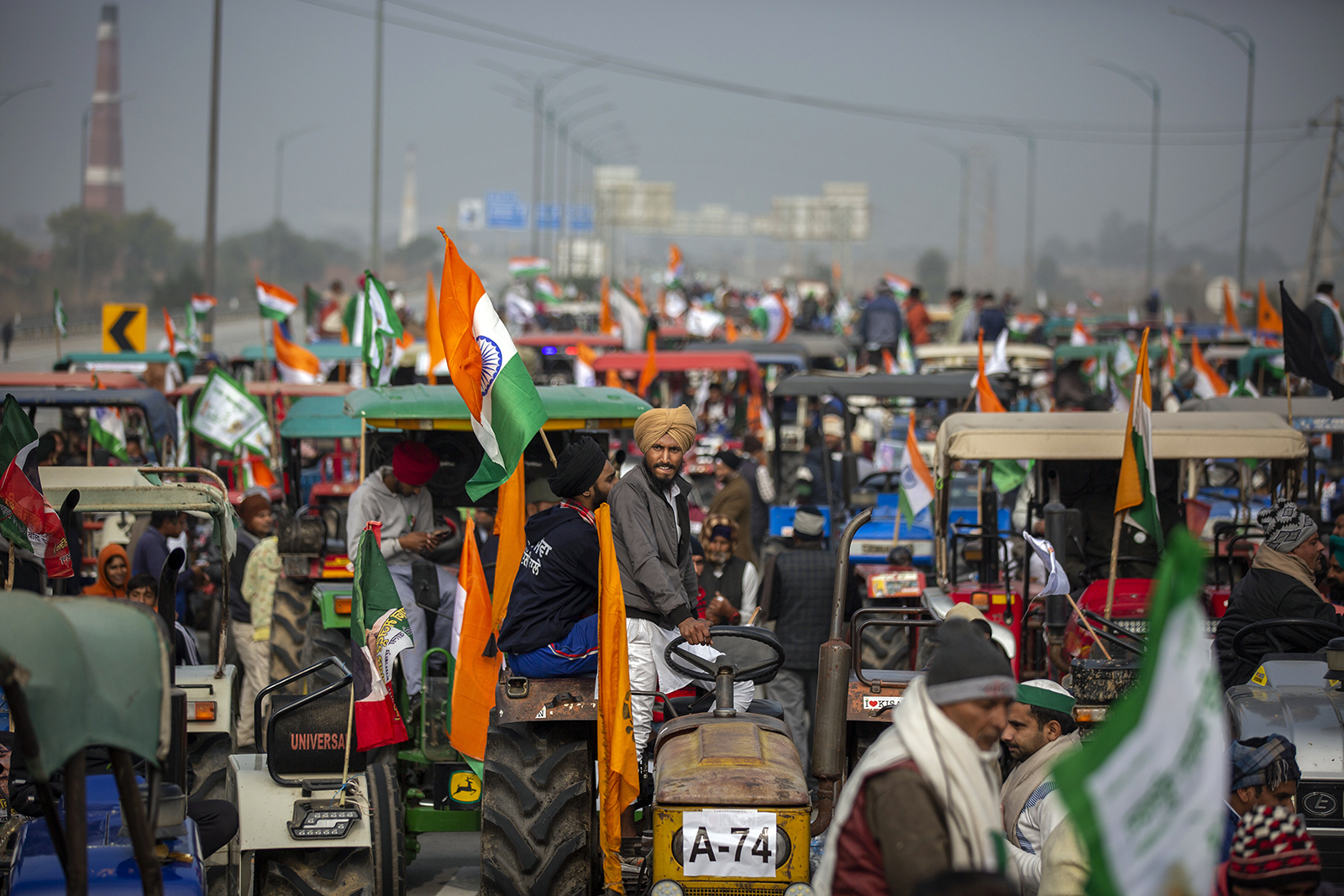 Indian farmers participate in a tractor rally in a protest against new farm laws at Ghaziabad, on the outskirts of New Delhi, on Jan. 7, 2021. India’s top court temporarily put on hold the implementation of new agricultural laws and ordered the formation of an independent committee of experts to negotiate with farmers who have been protesting against the legislation. (AP Photo/Altaf Qadri, File)
