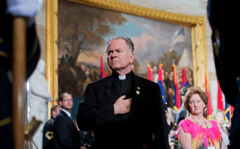 The Rev. Patrick Conroy, chaplain of the House, attends the 2013 National Days of Remembrance ceremony in the Capitol rotunda to honor the victims of the Holocaust on April 11, 2013. (Photo By Tom Williams/CQ Roll Call via AP)
