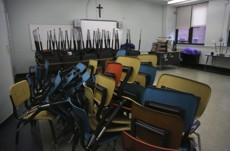 In this Aug. 6, 2020, file photo, desks and chairs are stacked in an empty classroom after the permanent closure of Queen of the Rosary Catholic Academy in Brooklyn borough of New York. On Feb. 8, 2021, Catholic education officials reported that enrollment in Roman Catholic schools in the United States dropped 6.4% from the previous academic year amid the pandemic and economic stresses — the largest single-year decline in at least five decades. (AP Photo/Jessie Wardarski)