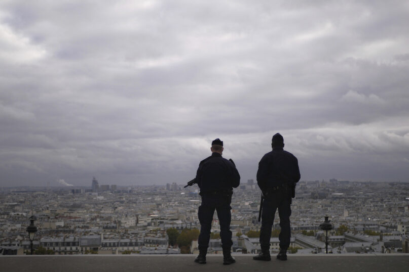 FILE - In this Oct. 30, 2020, file photo, police officers stand guard next to the Sacre Coeur basilica in Paris, following an attack at a church in the Mediterranean city of Nice. Scrubbing France clean of radicals and their breeding grounds is a priority cause of President Emmanuel Macron in a nation bloodied by terror attacks, including the beheading of a teacher outside his school in a Paris suburb followed by a deadly attack inside the basilica in Nice. (AP Photo/Thibault Camus)