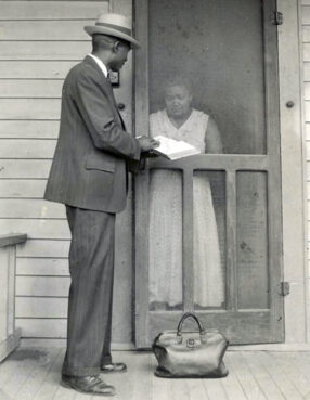 Henry Dray shows a Bible to a woman, circa 1876. Photo courtesy American Bible Society