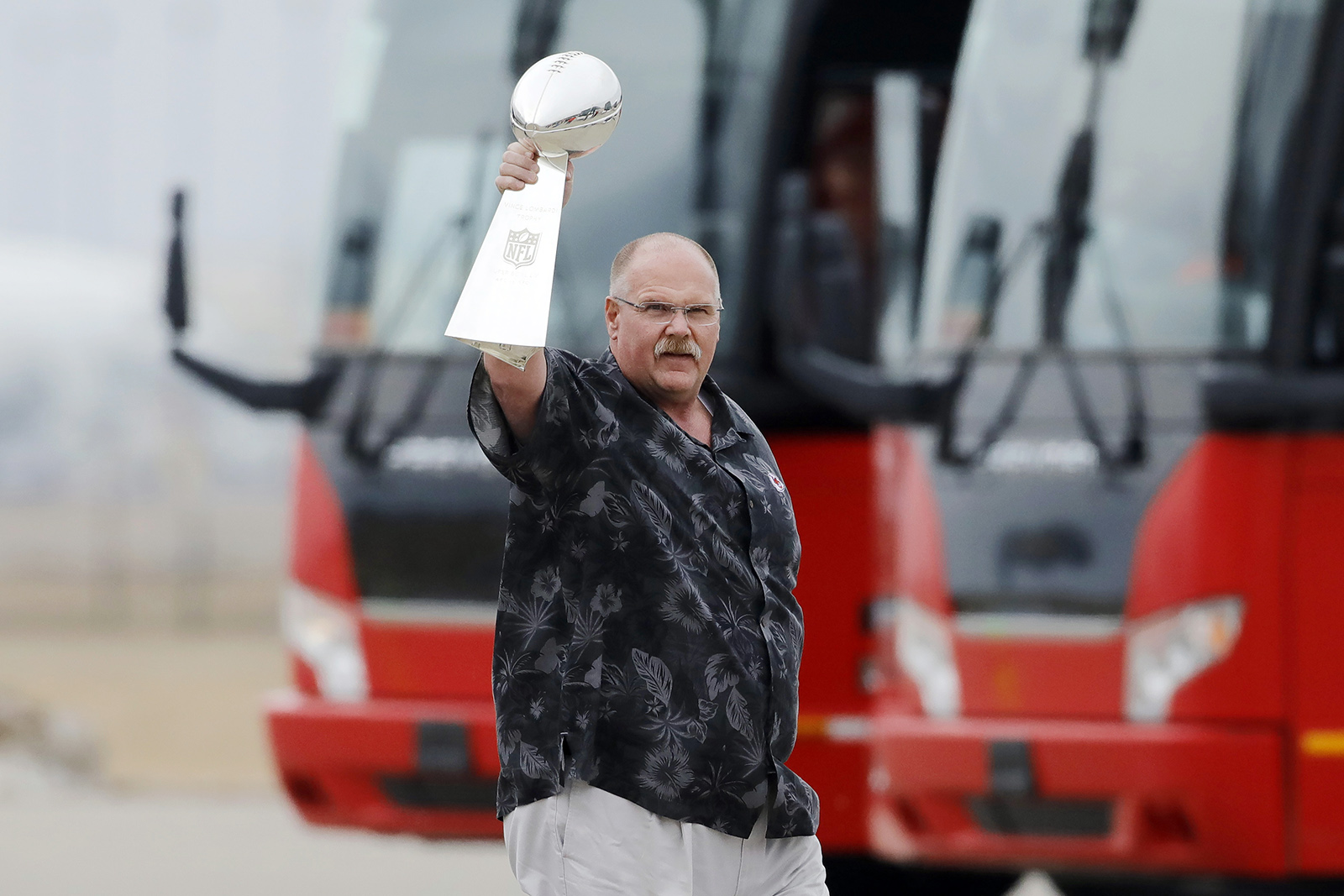 Kansas City Chiefs head coach Andy Reid holds up the Vince Lombardi Trophy as his team returns home a day after winning the NFL Super Bowl 54 football game, Monday, Feb. 3, 2020, in Kansas City, Mo. The Chiefs defeated the San Francisco 49ers 31-20, to win their first championship in 50 years. (AP Photo/Colin E. Braley)