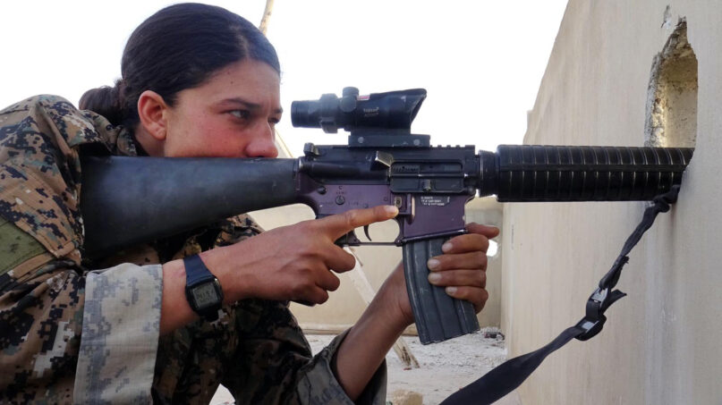 A YPJ sharpshooter scans for IS fighters. Photo courtesy of “The Daughters of Kobani”