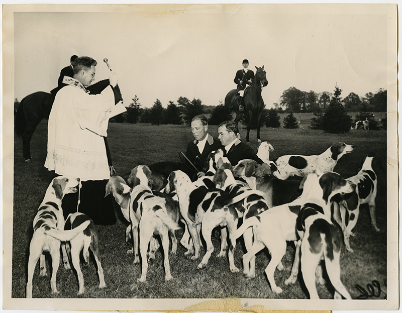 The Rev. Harold Jochem, of St. Francis Retreat, blesses hounds before the hunt at the Oak Brook Hunt Club in Hinsdale, Ill., circa 1948. The annual Oak Brook hunt season got under way, but not before the annual blessing. Kneeling before the priest are Paul A. Butler and T.A. Mohlman, joint masters of the fox hounds for the Oak Brook Hunt Club. The blessing is a traditional English and Irish ceremony. RNS archive photo by Ed Wagner. Photo courtesy of the Presbyterian Historical Society