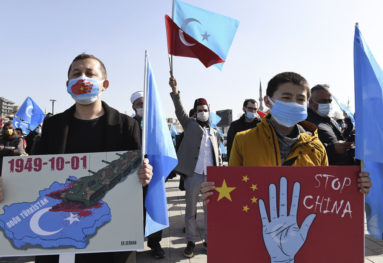 Members of the Uyghur community living in Turkey, hold banners as they join a protest against China, in Istanbul, Friday, Feb. 26, 2021. More than a million Uyghurs and other largely Muslim minorities have been swept into prisons and detention camps in China, in what China calls an anti-terrorism measure. Uyghurs, a Turkic group native to China's far west Xinjiang region, have sought refuge in Turkey for decades because of their shared cultural ties with the country. (AP Photo/Omer Kuscu)