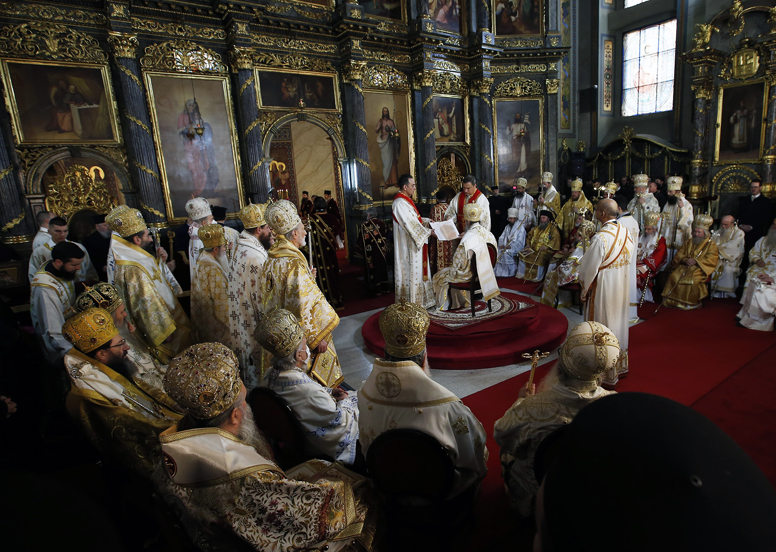 The new head of the Serbian Orthodox Church, Patriarch Porfirije, seated center, performs the liturgy ceremony in Belgrade's Congregational Church, Serbia, Friday, Feb. 19, 2021. Patriarch Porfirije replaces Patriarch Irinej, who died in November 2020 from COVID-19 complications. (AP Photo/Darko Vojinovic)