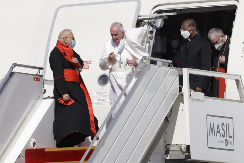 Pope Francis walks down the steps of an airplane as he arrives at Baghdad international airport, Iraq, Friday, March 5, 2021. Pope Francis heads to Iraq to urge the country’s dwindling number of Christians to stay put and help rebuild the country after years of war and persecution, brushing aside the coronavirus pandemic and security concerns. (AP Photo/Andrew Medichini)