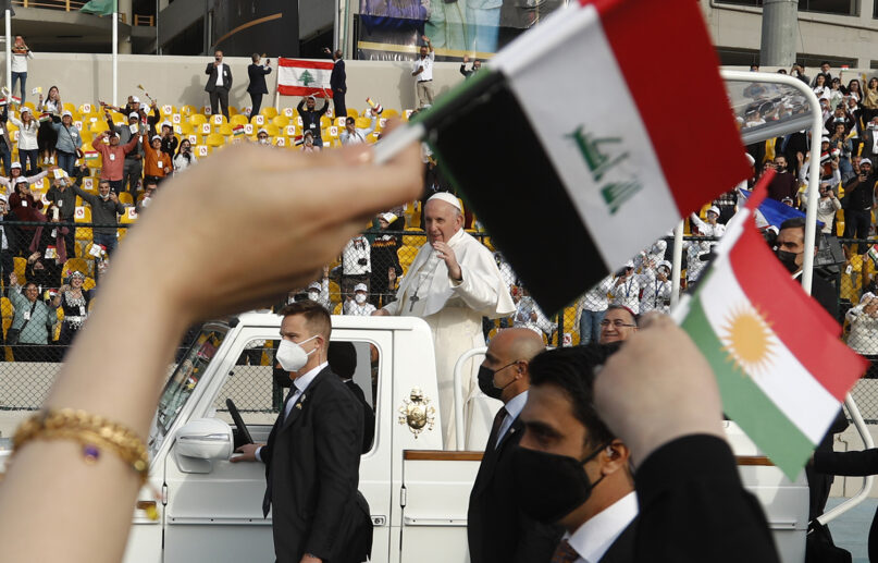 Pope Francis waves as he arrives for an open air Mass at a stadium in Irbil, Iraq, Sunday, March 7, 2021. Thousands of people filled the sports stadium in the northern city of Irbil for Pope Francis' final event in his visit to Iraq: an open-air Mass featuring a statue of the Virgin Mary that was restored after Islamic militants chopped of the head and hands. (AP Photo/Hadi Mizban)